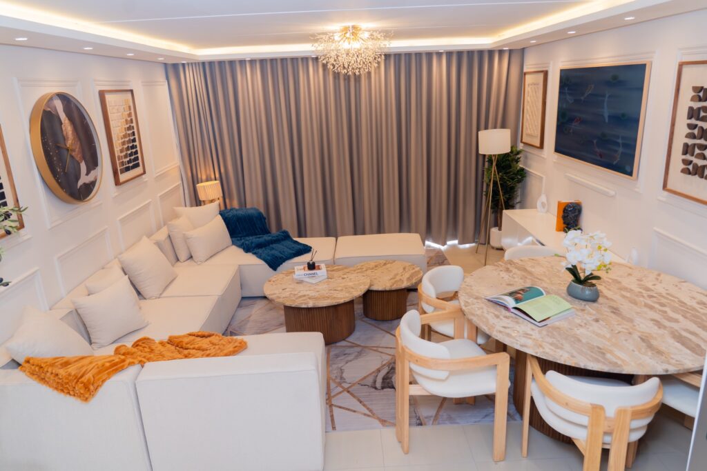 Sandton apartment open-plan living and dining area with a sectional sofa and round dining table
