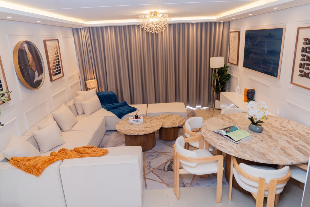 Sandton apartment open-plan living and dining area with a sectional sofa and round dining table