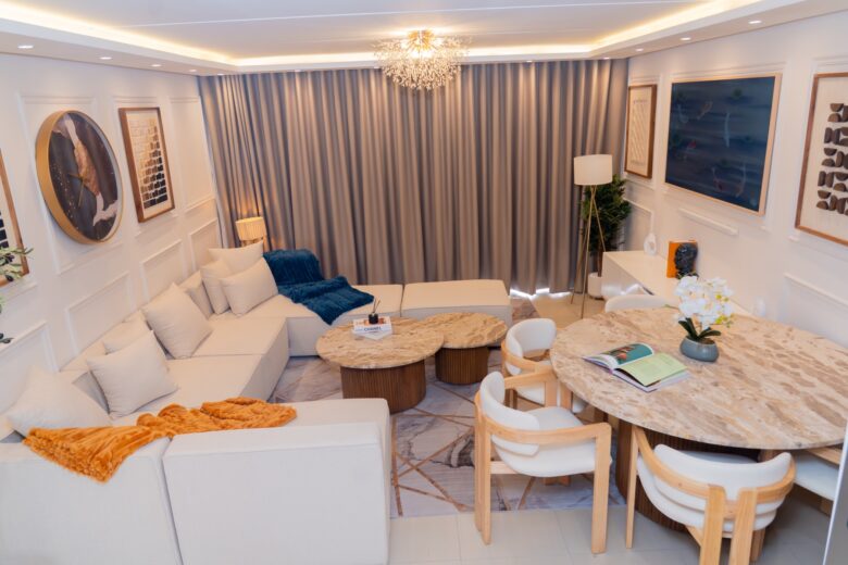 Sandton apartment open-plan living and dining area with a sectional sofa and round dining table